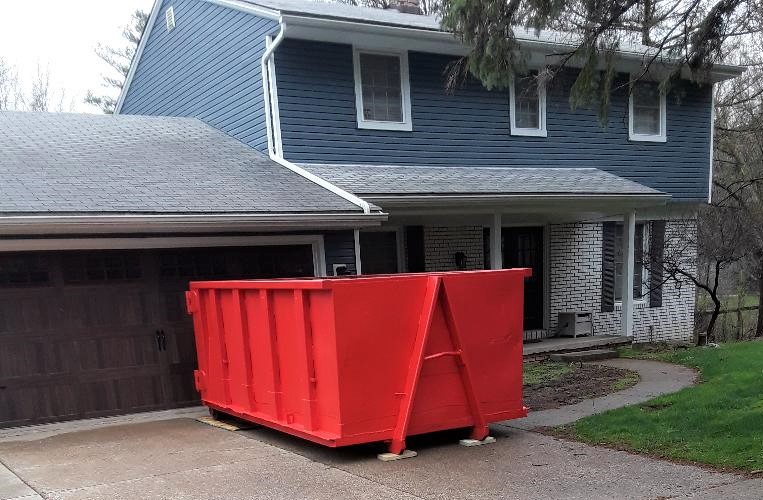 Dumpster in front of garage - All American Waste Management